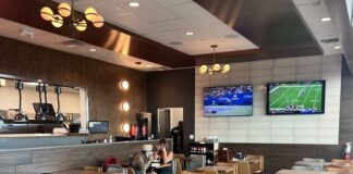 a restaurant filled with lots of tables and chairs