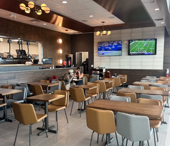 a restaurant filled with lots of tables and chairs