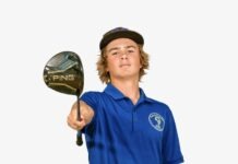 a boy in a blue shirt holding a golf club