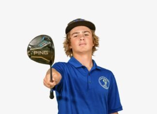 a boy in a blue shirt holding a golf club