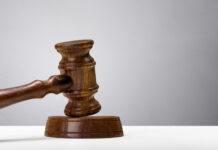 a wooden judge's gaven on a white table