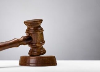a wooden judge's gaven on a white table