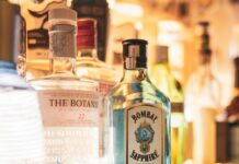 bottles of alcohol are lined up on a bar