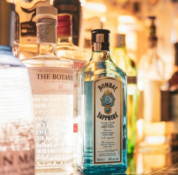 bottles of alcohol are lined up on a bar