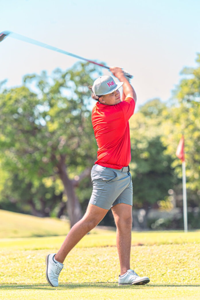 a man swinging a golf club on a golf course