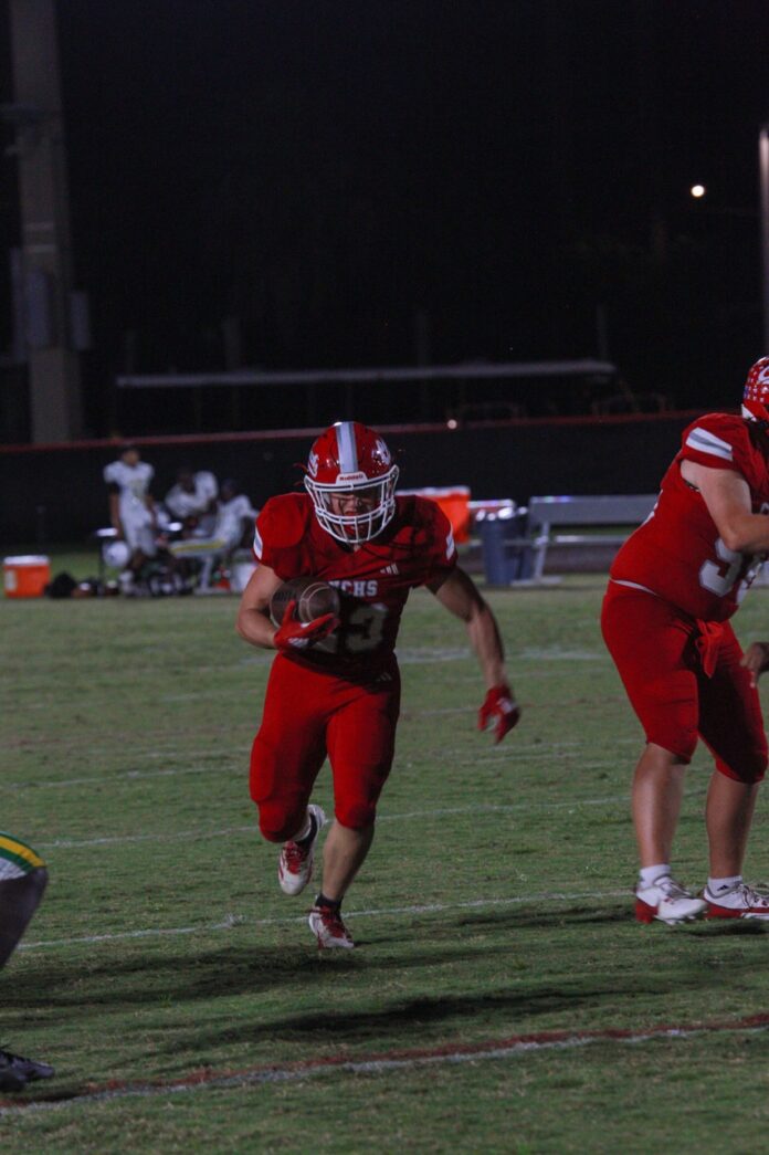 a football player running with the ball during a game