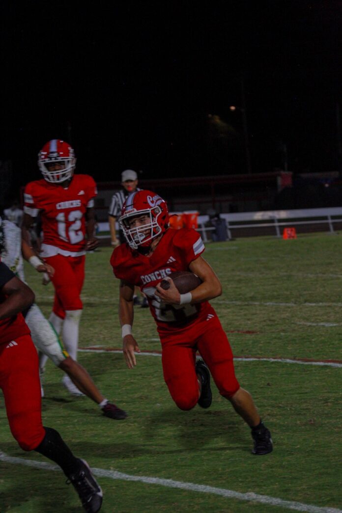 a football player running with the ball during a game