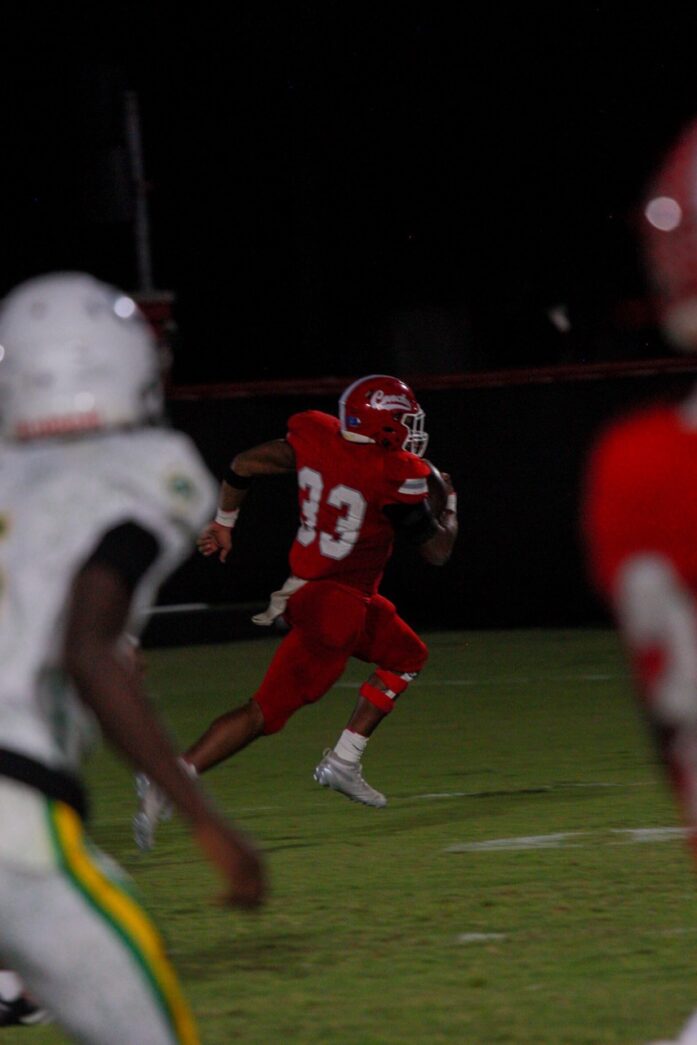 a football player running with the ball during a game