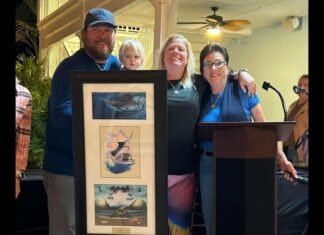 a group of people standing next to each other in front of a podium
