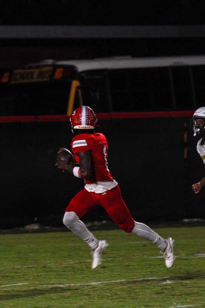 a football player running with the ball during a game