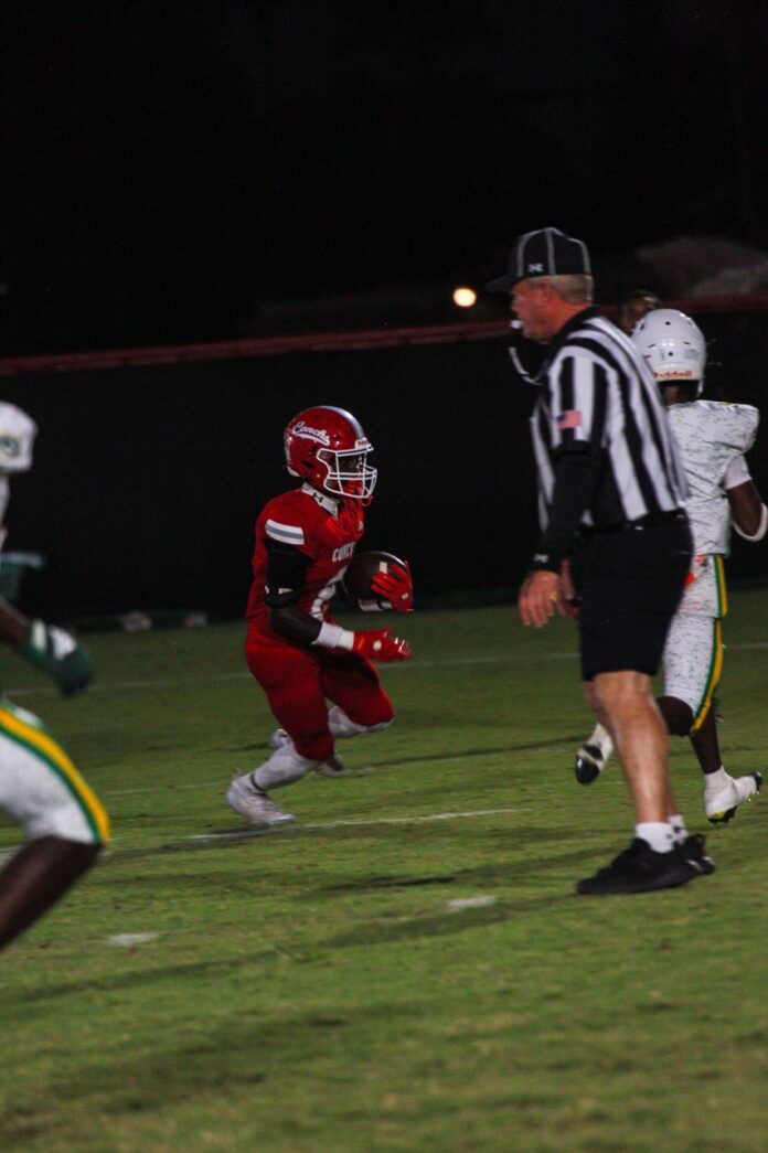 a football player running with the ball during a game