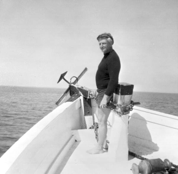 a man standing on the bow of a boat
