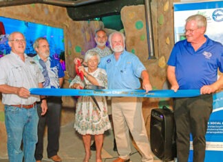 THE REEF, REIMAGINED: CRANE POINT REOPENS MUSEUM EXHIBIT WITH MOTE PARTNERSHIP a group of people holding a blue ribbon