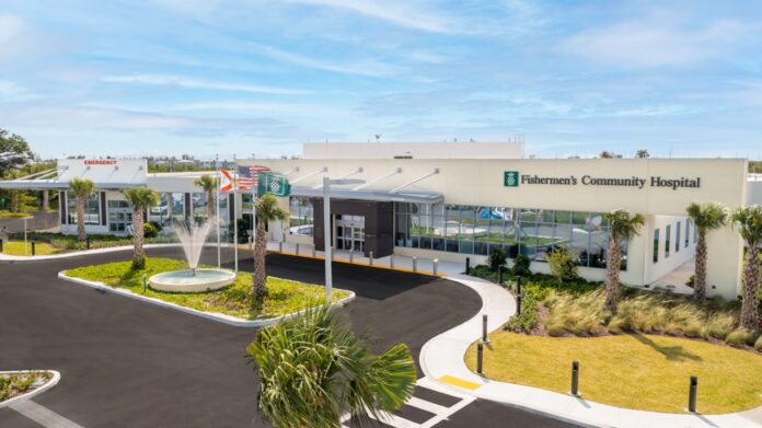 the front of a hospital with a fountain and palm trees