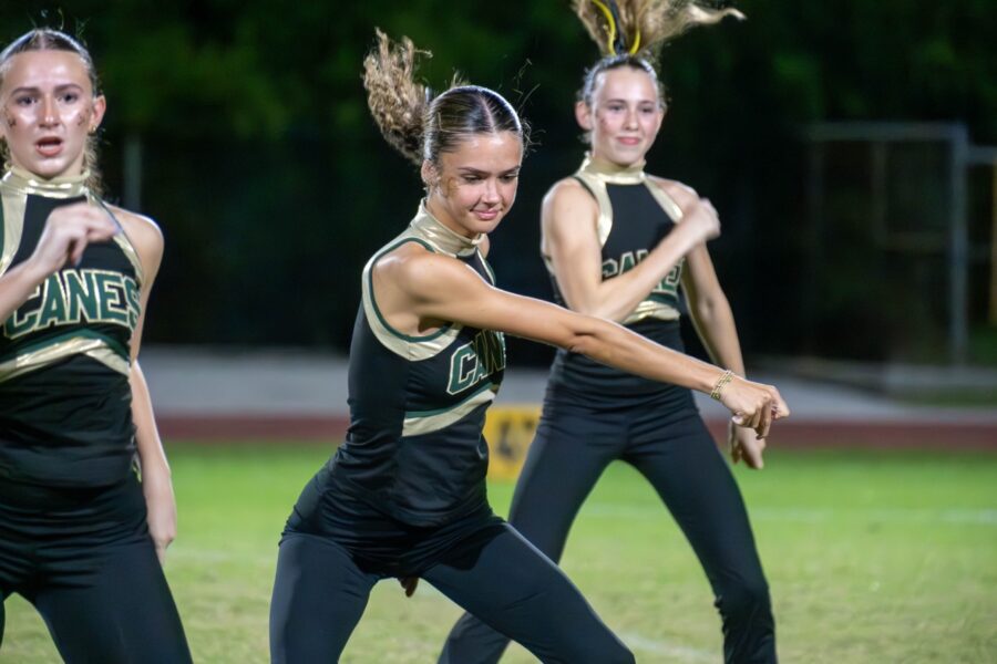 a group of young women standing on top of a field