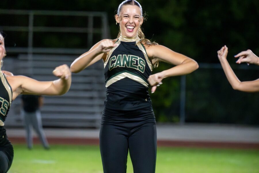 a group of young women standing on top of a field