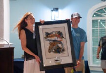 WINNERS CROWNED IN ANNUAL CASTING FOR CATS BACKCOUNTRY TOURNAMENT IN ISLAMORADA a man and a woman holding a framed picture