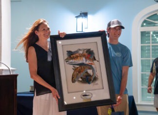 WINNERS CROWNED IN ANNUAL CASTING FOR CATS BACKCOUNTRY TOURNAMENT IN ISLAMORADA a man and a woman holding a framed picture