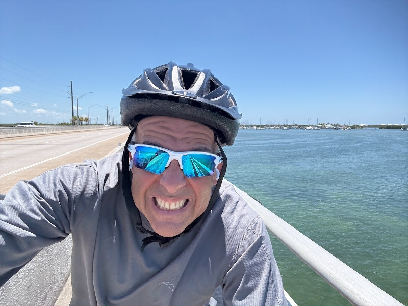 a man riding a bike on top of a bridge