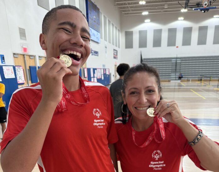 Chris and Alicia Unified Picklball Doubles a man and a woman eating food in a gym