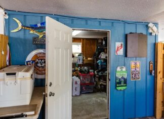 COUNTY NIXES DOWNSTAIRS ENCLOSURE RESTRICTIONS & WRESTLES WITH ROGO a room that has a bunch of items on the wall