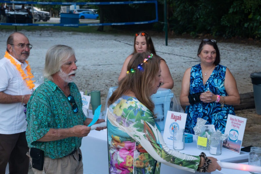 a group of people standing around a table
