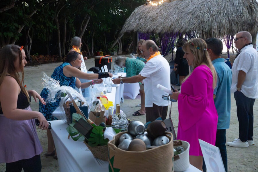 a group of people standing around a table