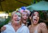 a group of women with face paint posing for a picture