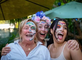 LOCAL BREWERY HOSTS DAY OF THE DEAD CELEBRATION a group of women with face paint posing for a picture