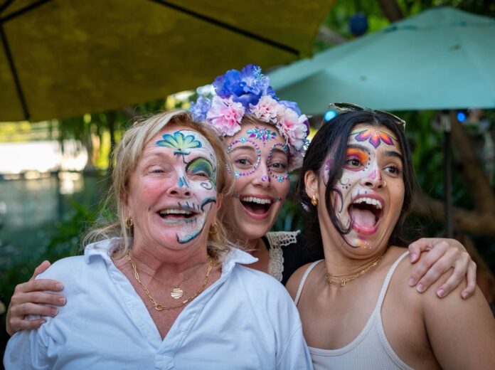 a group of women with face paint posing for a picture