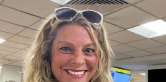 a woman wearing sunglasses and a black top