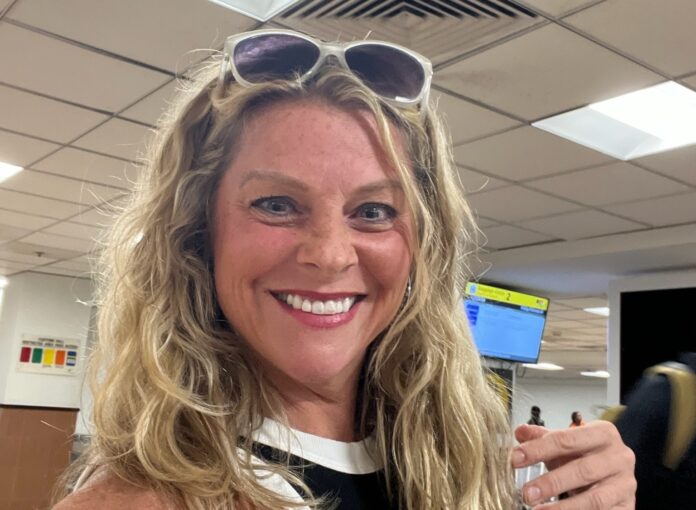 a woman wearing sunglasses and a black top