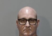 a mug shot of a man wearing glasses