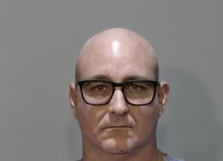 a mug shot of a man wearing glasses