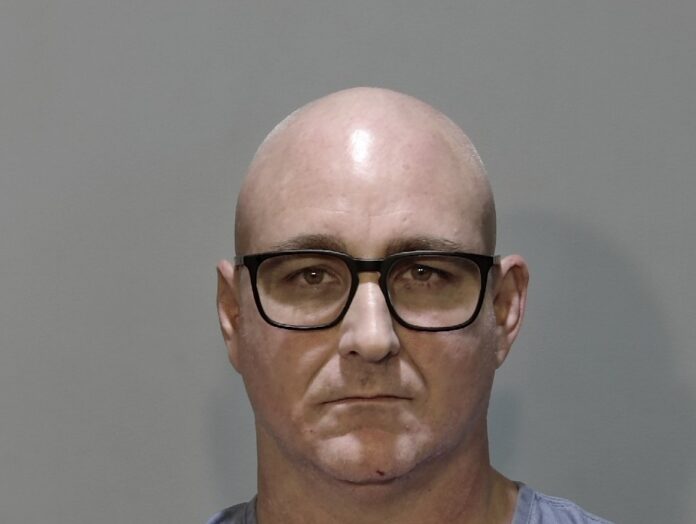 a mug shot of a man wearing glasses