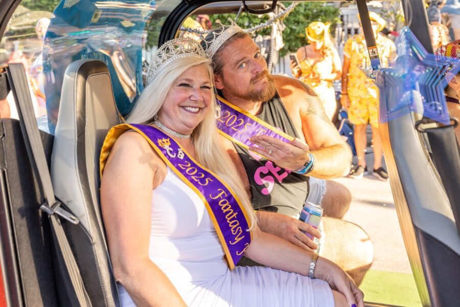 a man and woman sitting in the back of a truck
