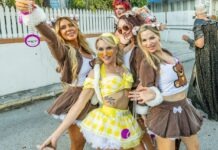 a group of women in costumes posing for a picture