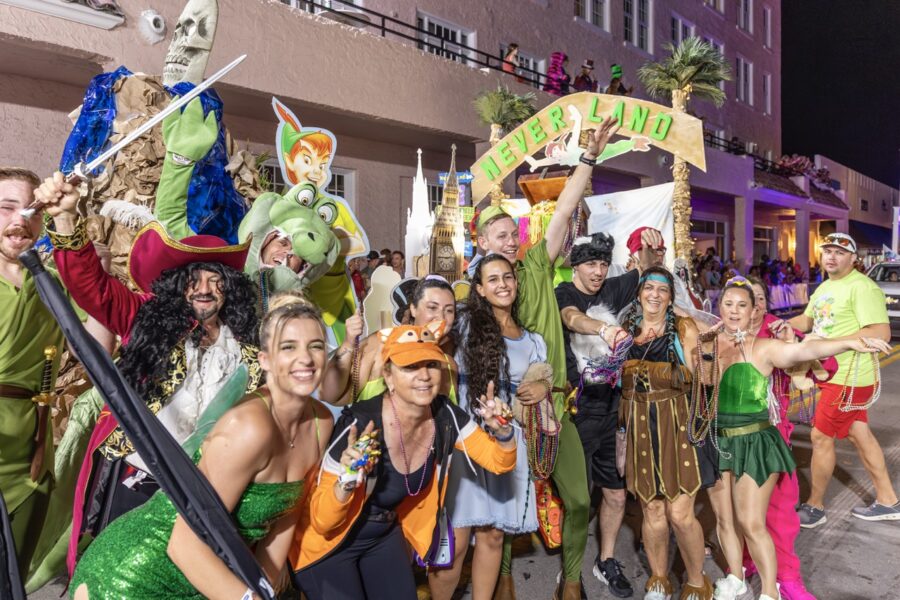 a group of people standing on the side of a road