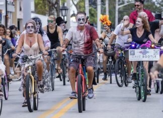 IN PICTURES: KEY WEST’S ZOMBIE ZONE  a group of people riding bikes down a street