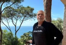 CELEBRATE THE LIFE OF GORDON ROSS ON NOV. 10 a man standing on a porch next to a tree