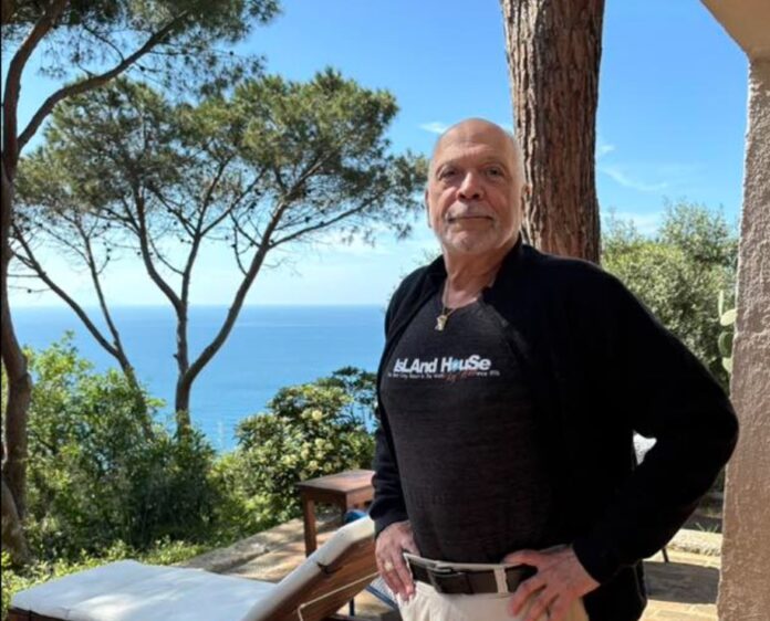 Screenshot a man standing on a porch next to a tree