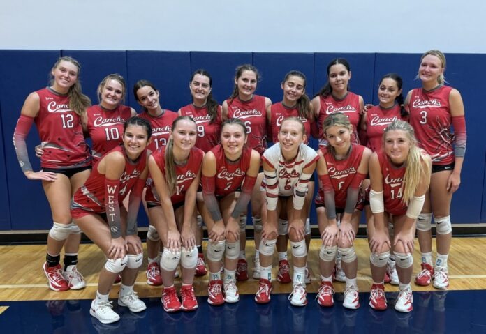 a group of women's volleyball players posing for a team photo