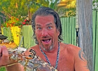 MARATHON NEIGHBOR OF THE WEEK: MICHAEL INGALSBE a man holding a large lobster in his hand