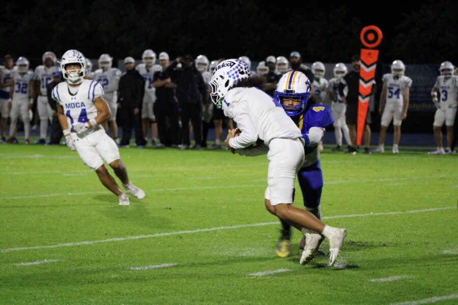 a football player running with the ball during a game