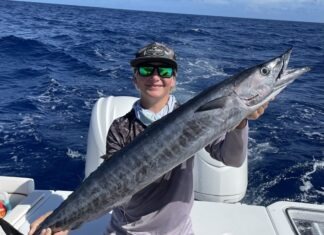 GET YOUR LINES READY: MARATHON FIRE RESCUE BENEVOLENT WAHOO TOURNEY IS NEXT MONTH a man on a boat holding a large fish