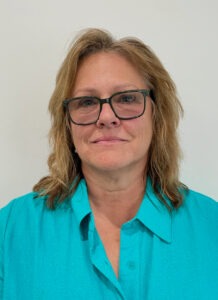 a woman wearing glasses and a blue shirt