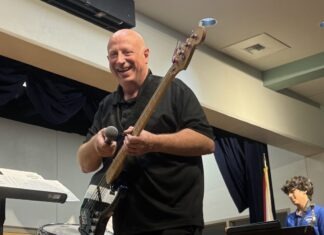a man standing on a stage with a guitar