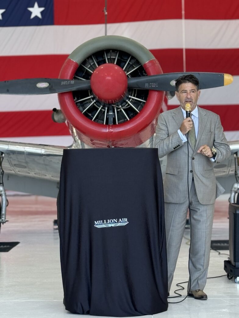 a man standing in front of a red and white airplane