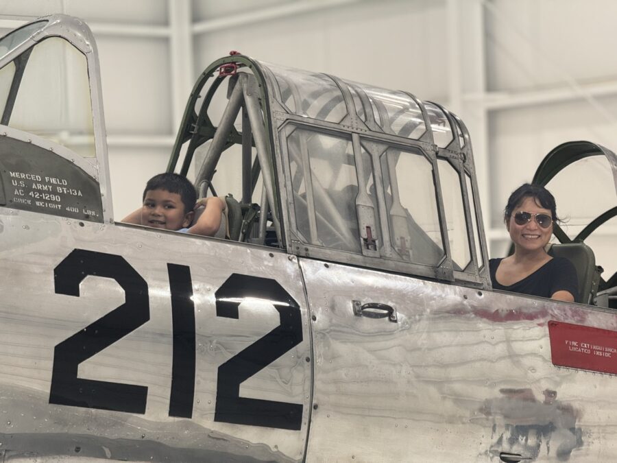 a woman and a child are sitting in an airplane