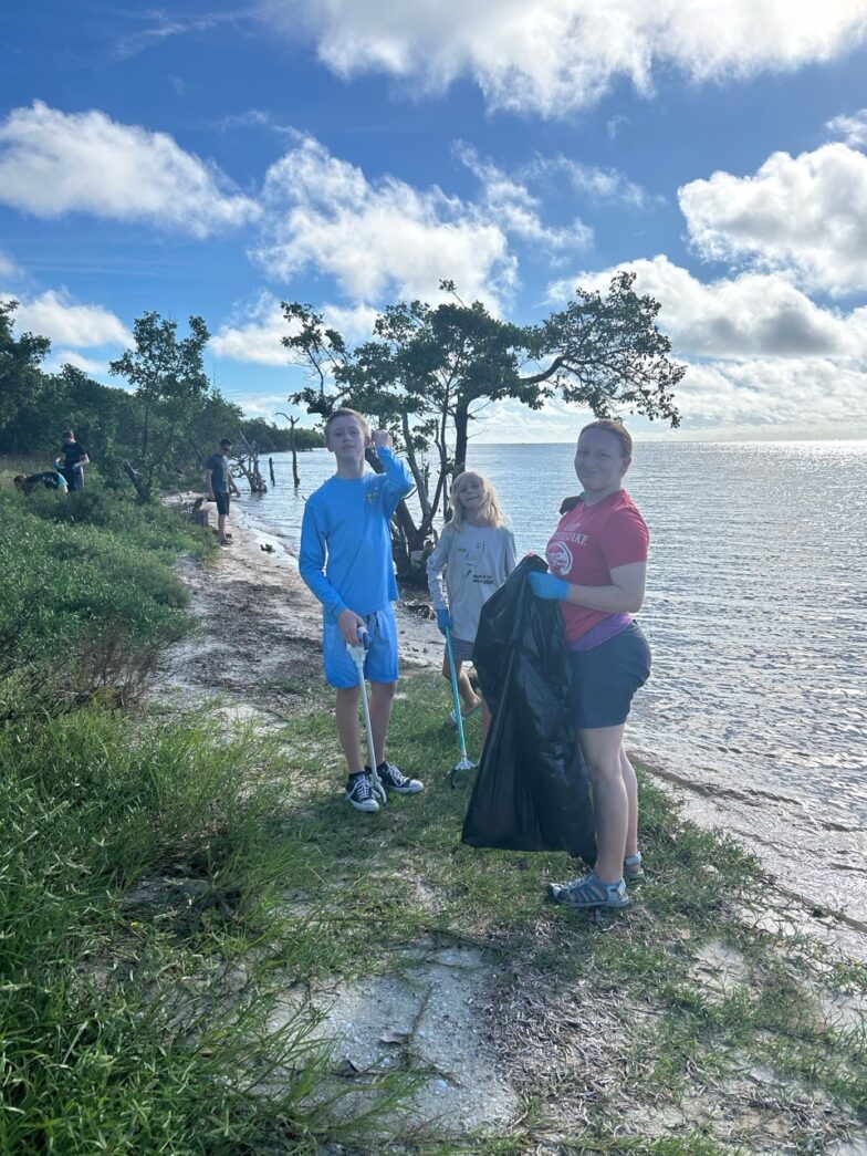 a group of people standing next to a body of water
